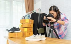 woman taking photo to shoes to sell